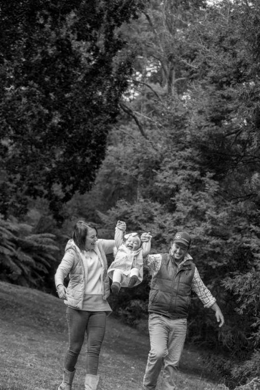 Mum and Dad and baby daughter playing in the park. Copyright Erika's Way Photography