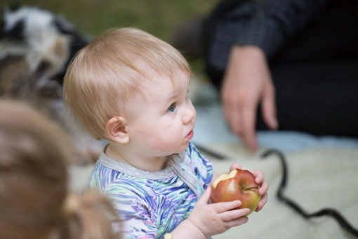 Baby Emmeline eating an apple